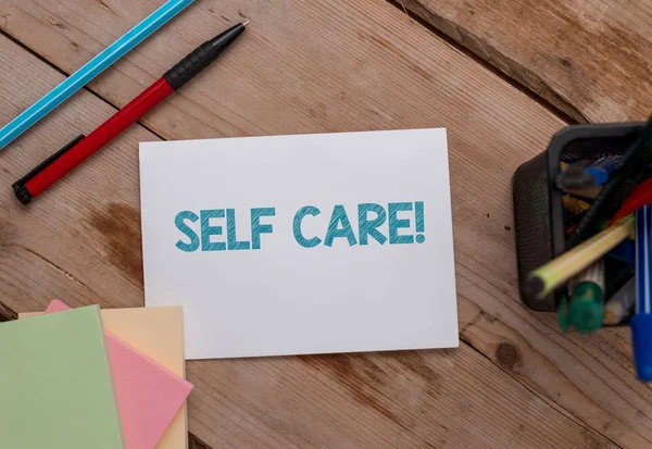 Conceptual hand writing showing Self Care. Business photo showcasing practice of taking action to preserve or improve ones own health Note papers and stationary placed sideways softhued backdrop. — Stock Photo, Image