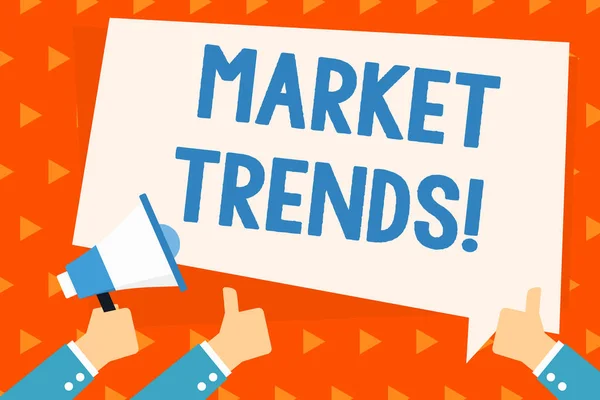 Word writing text Market Trends. Business concept for Changes and developments in buying and selling in the market Hand Holding Megaphone and Other Two Gesturing Thumbs Up with Text Balloon.