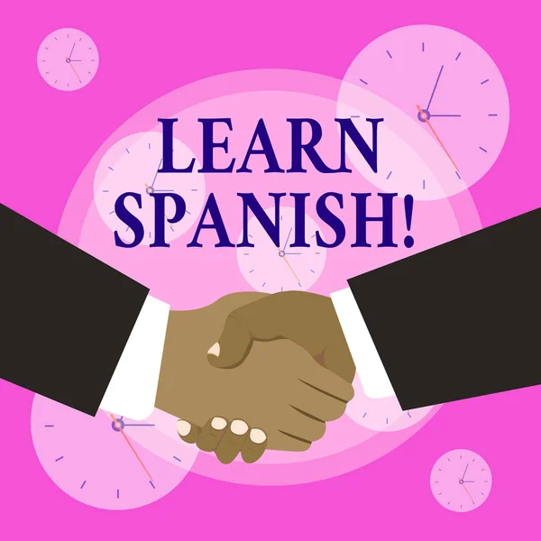Conceptual hand writing showing Learn Spanish. Business photo showcasing gain or acquire knowledge of speaking and writing Spanish Hand Shake Multiracial Male Business Partners Formal Suits.