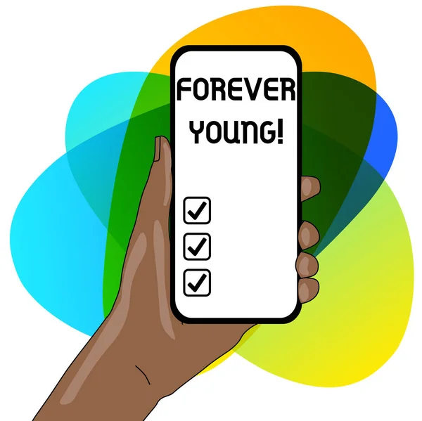 Woord schrijven tekst Forever Young. Business concept voor mindset van een wezen fris en zorgeloos, ongeacht de leeftijd Closeup van Smartphone Device Held in Hand met Leeg Scherm en Tekstruimte. — Stockfoto