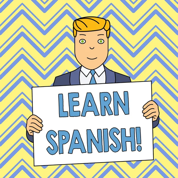 Word writing text Learn Spanish. Business concept for gain or acquire knowledge of speaking and writing Spanish Smiling Man Holding Formal Suit Big Blank Poster Board in Front of Himself.