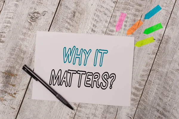 Handwriting text Why It Matters Question. Concept meaning most important thing to be done when involved in situation Plain note paper and line arrow stickers with pen above the wooden table.
