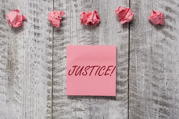 Word writing text Justice. Business concept for impartial adjustment of conflicting claims or assignments Thick set of plain note paper with scraps on the wooden textured table. — 스톡 사진