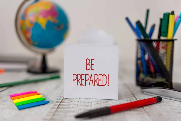 Sinal de texto mostrando Be Prepared. Foto conceitual tente estar sempre pronto para fazer ou lidar com algo folhas estacionárias e de papel, além de pequenas setas com globo na mesa de madeira . — Fotografia de Stock