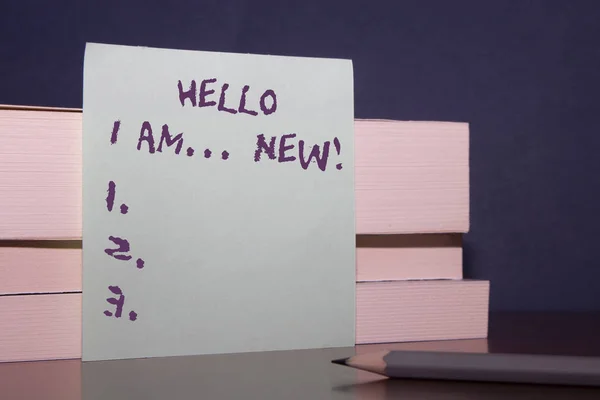 Text sign showing Hello I Am New. Conceptual photo used as greeting or to begin telephone conversation Close up three wooden different sizes rectangle boxes paper sheet pencil.