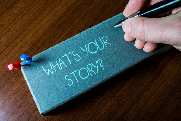 Writing note showing What S Your Story Question. Business photo showcasing asking demonstrating about his past life actions events Close up left man right hand holding pen fixed pins lying wooden — 스톡 사진