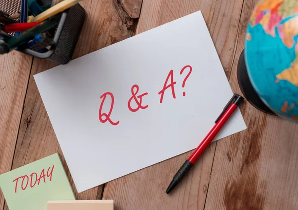 Word writing text Q And A Question. Business concept for in which demonstrating asks questions and another one answers them Writing equipments and sheets with artificial globe on the wooden desk. — 스톡 사진
