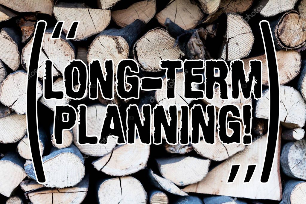 Handwriting text Long Term Planning. Concept meaning establishing goals that you expected to achieve Background dry chopped firewood logs stacked up in a pile winter chimney.