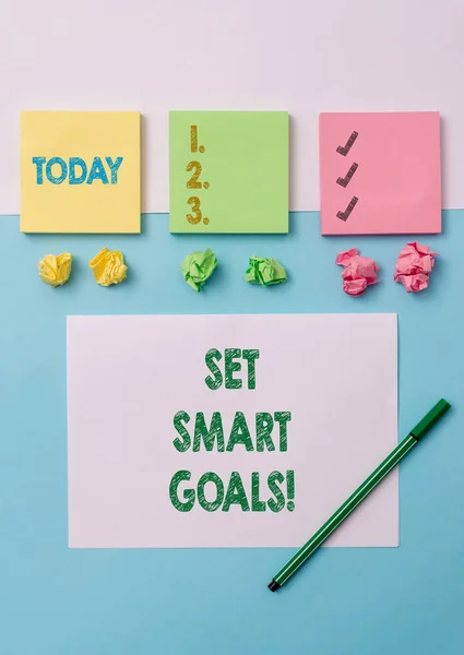 Conceptual hand writing showing Set Smart Goals. Business photo text list to clarify your ideas focus efforts use time wisely Stationary placed sideways on top of the softhued backdrop.