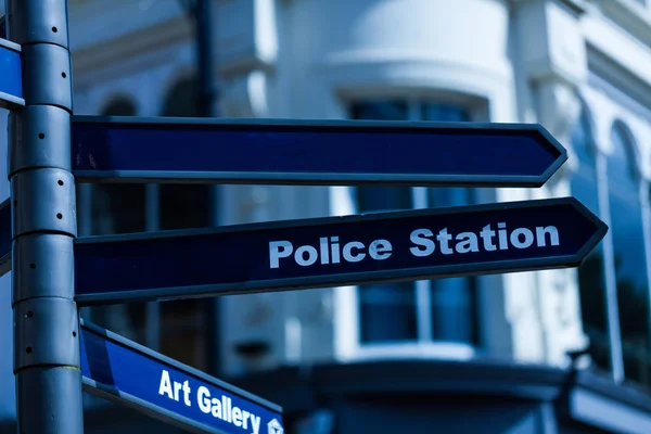 Classic Britain metal signpost three banners Police Station Art Gallery one blank to write in United Kingdom traditional signing Attraction, Streets, Public Services — Stock Photo, Image