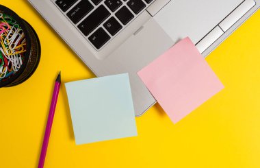 Front view open trendy metallic silver slim laptop blank sticky notes pencil clips container colored background. Empty text important events. What to do school office home
