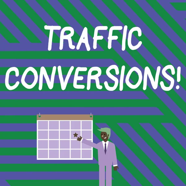 Handwriting text writing Traffic Conversions. Concept meaning visitor who has been converted into a client or customer Businessman Smiling and Pointing to Colorful Calendar with Star Hang on Wall. — стокове фото