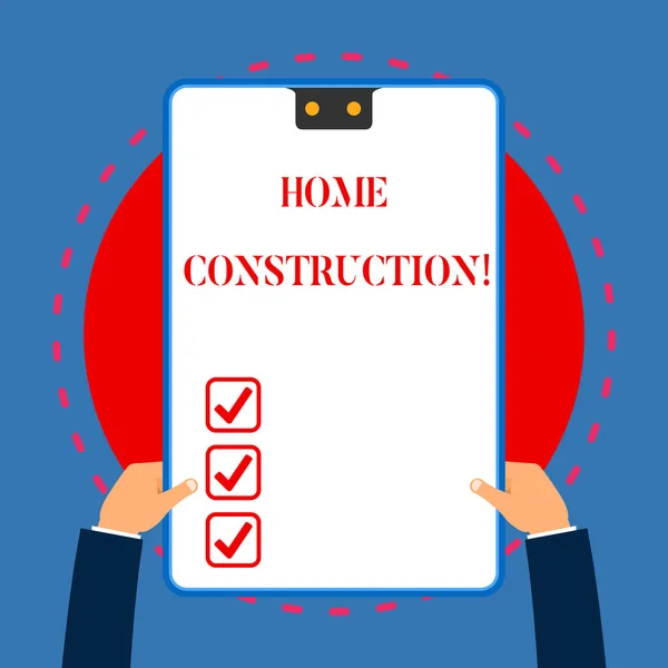 Handwriting text writing Home Construction. Concept meaning the process of constructing a living accommodation White rectangle clipboard with blue frame has two holes holds by hands.