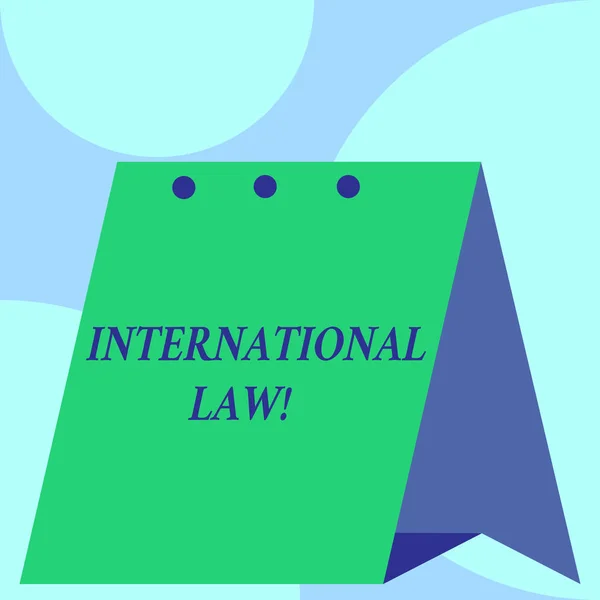 Text sign showing International Law. Conceptual photo system of treaties and agreements between nations Open big standing calendar Desk monthly planner Geometrical background.
