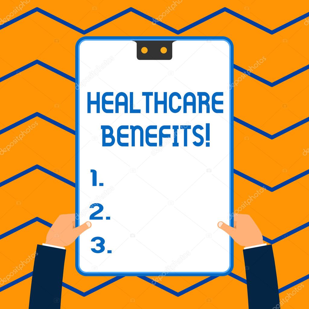 Word writing text Healthcare Benefits. Business concept for monthly fair market valueprovided to Employee dependents White rectangle clipboard with blue frame has two holes holds by hands.