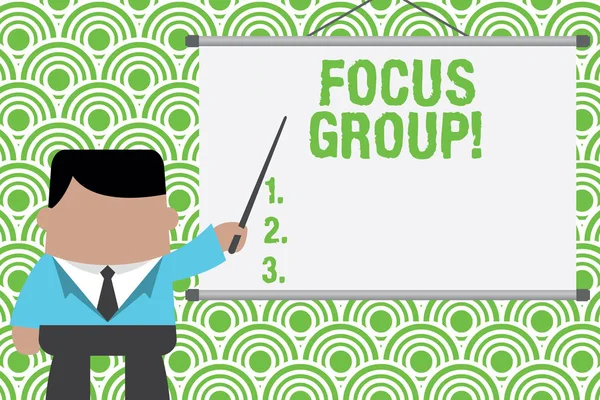 Text sign showing Focus Group. Conceptual photo showing assembled to participate in discussion about product Businessman standing in front projector screen pointing project idea. — Stock Photo, Image