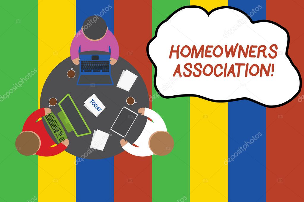 Conceptual hand writing showing Homeowners Association. Business photo showcasing Organization with fee for upkeeps of Gated Community Working table male employees electronic devices coffee cup.