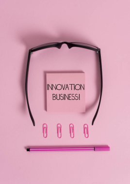 Handwriting text Innovation Business. Concept meaning Introduce New Ideas Workflows Methodology Services Colored blank sticky note clips binders eyeglasses pen trendy background. clipart