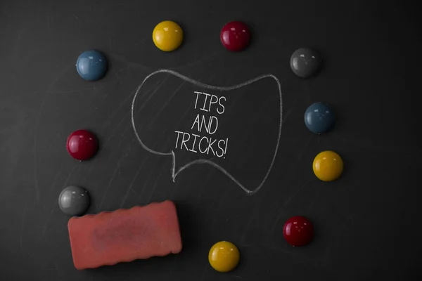 Handwriting text writing Tips And Tricks. Concept meaning means piece advice maybe suggestion how improve Round Flat shape stones with one eraser stick to old chalk black board.