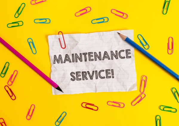 Conceptual hand writing showing Maintenance Service. Business photo showcasing Keep a Product Service in Good Operating Condition Blank crushed paper sheet message pencils colored background.