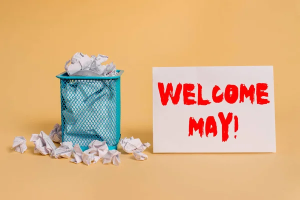 Handwriting text Welcome May. Concept meaning welcoming fifth month of year usually considered summer crumpled paper trash and stationary with empty paper placed in trash can.