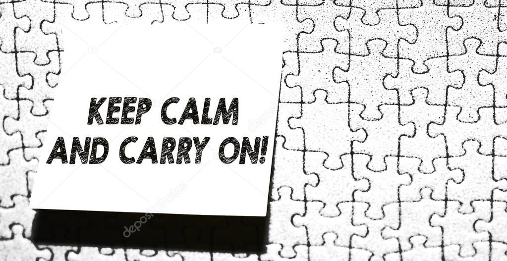 Word writing text Keep Calm And Carry On. Business concept for slogan calling for persistence face of challenge Piece of square note paper use for give notation stick to puzzle background.