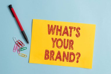 Handwriting text What S Your Brand Question. Concept meaning asking about product logo does or what you communicate Plain cardboard and writing equipment placed above pastel colour backdrop. clipart