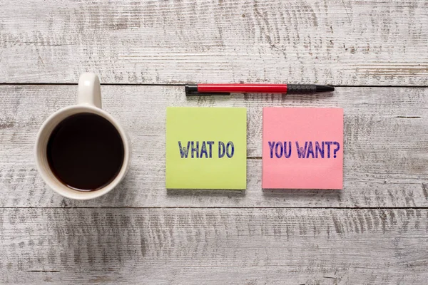 Text sign showing What Do You Want Question. Conceptual photo say or write in order to ask demonstrating about something Stationary placed next to a cup of black coffee above the wooden table. — Stock Photo, Image