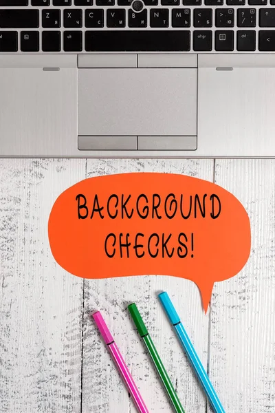 Handwriting text writing Background Checks. Concept meaning looking up compiling criminal records for Organization Open laptop blank speech bubble pens ballpoints lying vintage wooden table.