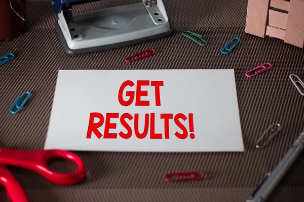 Text sign showing Get Results. Conceptual photo caused or produced by something else Consequence outcome Scissors and writing equipments plus plain sheet above textured backdrop.