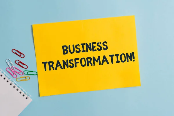 Text sign showing Business Transformation. Conceptual photo Align their Trade models with Strategy Improvement Plain cardboard and writing equipment placed above pastel colour backdrop.