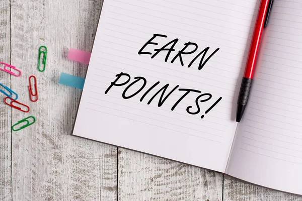 Conceptual hand writing showing Earn Points. Business photo text collecting big scores in order qualify to win big prize Notebook stationary placed above classic wooden backdrop.