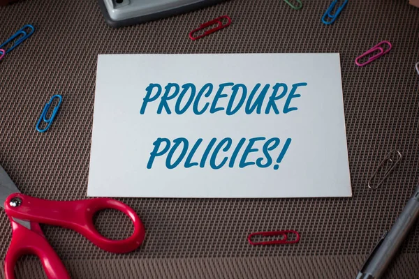 Text sign showing Procedure Policies. Conceptual photo Steps to Guiding Principles Rules and Regulations Scissors and writing equipments plus plain sheet above textured backdrop.