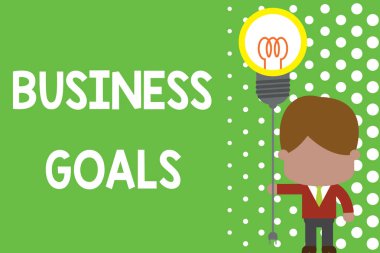 Text sign showing Business Goals. Conceptual photo Expectation to accomplish over a specific period of time Standing man tie holding plug socket light bulb to connect idea. Startup.
