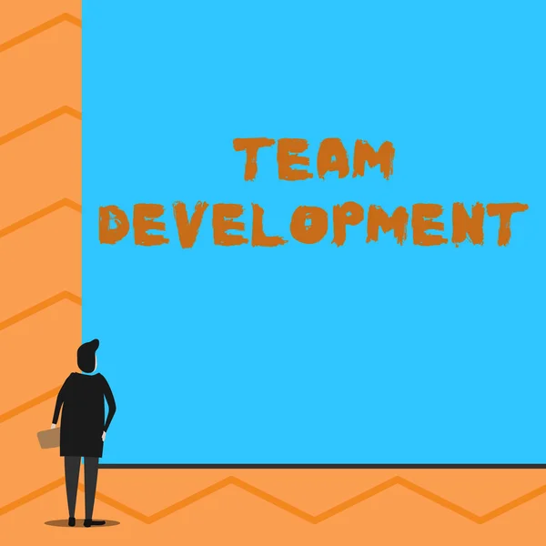 Text sign showing Team Development. Conceptual photo learn why and how small groups change over time with graphs Man stands in back view in front of huge empty blank big rectangle board. — Stock Photo, Image