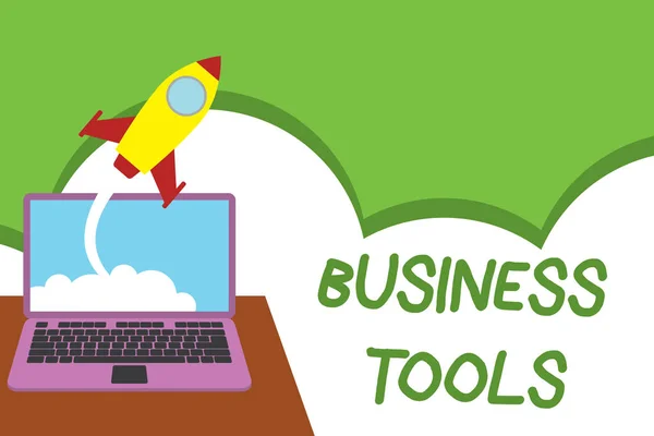 Text sign showing Business Tools. Conceptual photo Marketing Methodologies Processes and Technologies use Successful rocket launching clouds out laptop background. Startup growing.