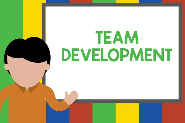 Writing note showing Team Development. Business photo showcasing learn why and how small groups change over time with graphs Young man standing in front whiteboard pointing to project. photo Art. — Stock Photo, Image