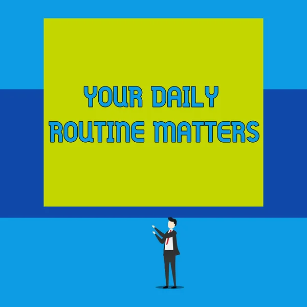 Word writing text Your Daily Routine Matters. Business concept for practice of regularly doing things in fixed order Isolated view young man standing pointing upwards two hands big rectangle.