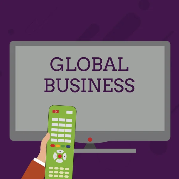 Word writing text Global Business. Business concept for Trade and business system a company doing across the world Hand Holding Computer Remote Control infront of Blank Wide Color PC Screen. — 스톡 사진