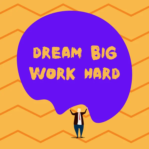 Text sign showing Dream Big Work Hard. Conceptual photo Believe in yourself and follow the dreams and goals Male human wear formal tuxedo hold asymmetrical shape bubble use both hands.