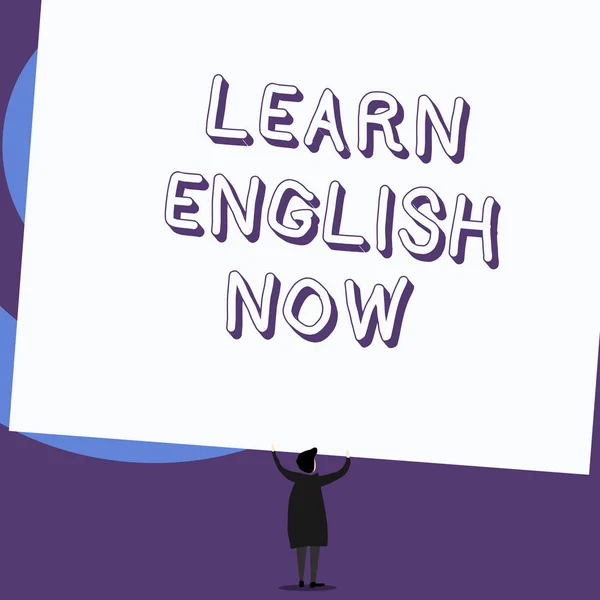 Writing note showing Learn English Now. Business photo showcasing gain or acquire knowledge and skill of english language Standing short hair woman dress hands up holding rectangle.