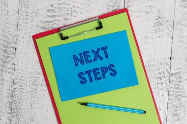 Sonraki Adımları gösteren metin işareti. Kavramsal fotoğraf başka bir şey bitirdikten sonra yaptığınız veya plan bir şey Renkli pano boş kağıt levha marker yapışkan not ahşap arka plan.