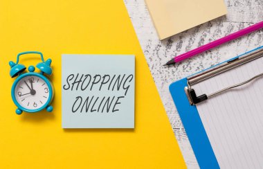 Kelime yazma metin Alışveriş Online. İnternet web sitesi üzerinden istediğiniz satın almak için Iş konsepti sonra Notepads pano renkli kağıt levha marker çalar saat ahşap arka plan teslim.