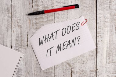 Kelime yazma metni Nedir Sorusu. Ahşap masanın üzerine yerleştirilen bir kalem ile belirsiz ifade Yırtık kağıt ve defter levha iletişim kurmak için amaçlanan iş konsepti.