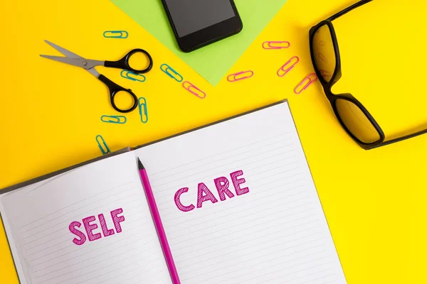 Word writing text Self Care. Business concept for the practice of taking action to improve one s is own health Sheet pencil clips smartphone scissors eyeglasses notepad color background. — Stock Photo, Image