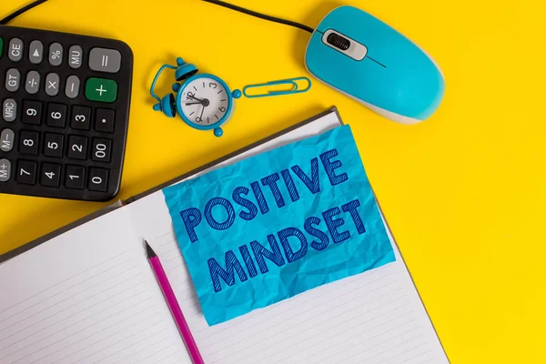 Writing note showing Positive Mindset. Business photo showcasing mental attitude in wich you expect favorable results Notebook calculator mouse pencil alarm clock sheet color background.
