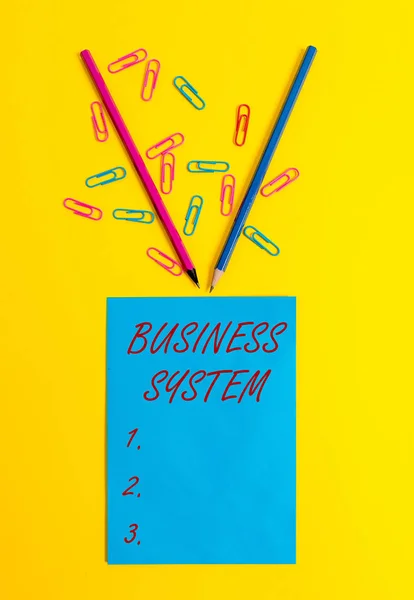 Word writing text Business System. Business concept for A method of analyzing the information of organizations Blank paper sheet message reminder pencils clips colored background. — Stock Photo, Image