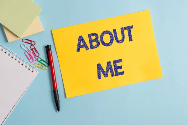 Writing note showing About Me. Business photo showcasing telling someone list of your good and bad traits and past events Plain cardboard and writing equipment placed on pastel colour backdrop.