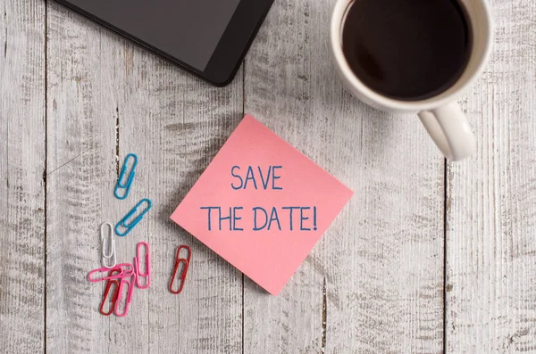Handwriting text writing Save The Date. Concept meaning reserve the mentioned future wedding date on their calendar Stationary placed next to a cup of black coffee above the wooden table. — Stock Photo, Image