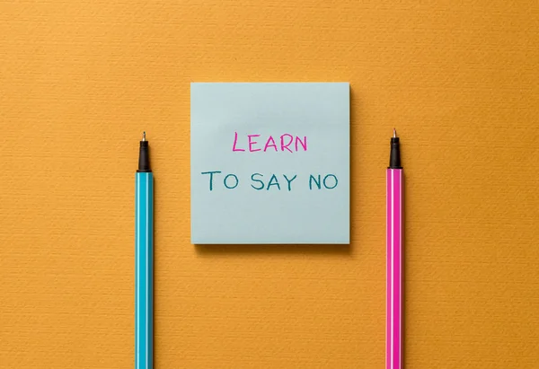 Text sign showing Learn To Say No. Conceptual photo decline or refuse few things before you destroy yourself Front view blank colored sticky note two ballpoints cool yolk background. — Stock Photo, Image